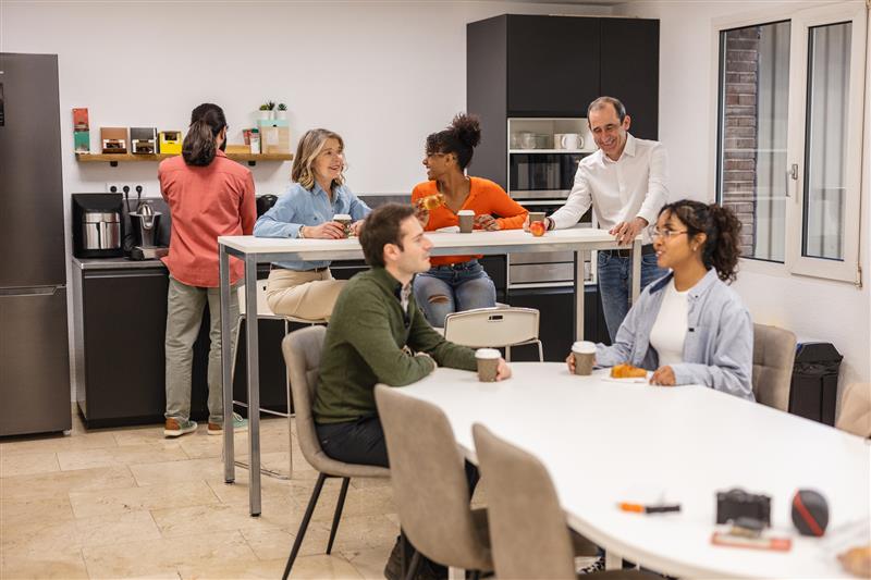 group of employees on a lunch break chatting in a break room
