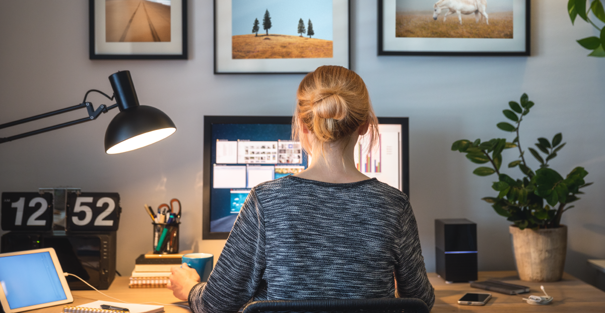 A woman working from home with her back to camera